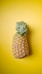 a pineapple sitting on top of a yellow surface