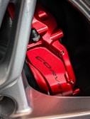 A close-up of vibrant custom painted brake calipers on a car.