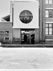Sturdy iron facade framing a modern building entrance with clean lines.