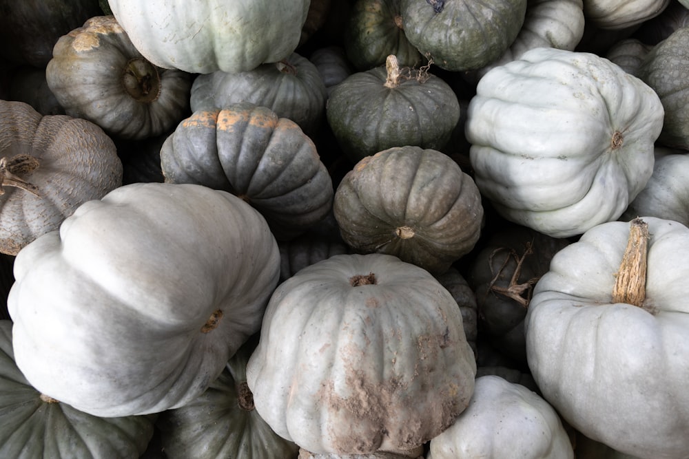 a pile of white pumpkins sitting next to each other