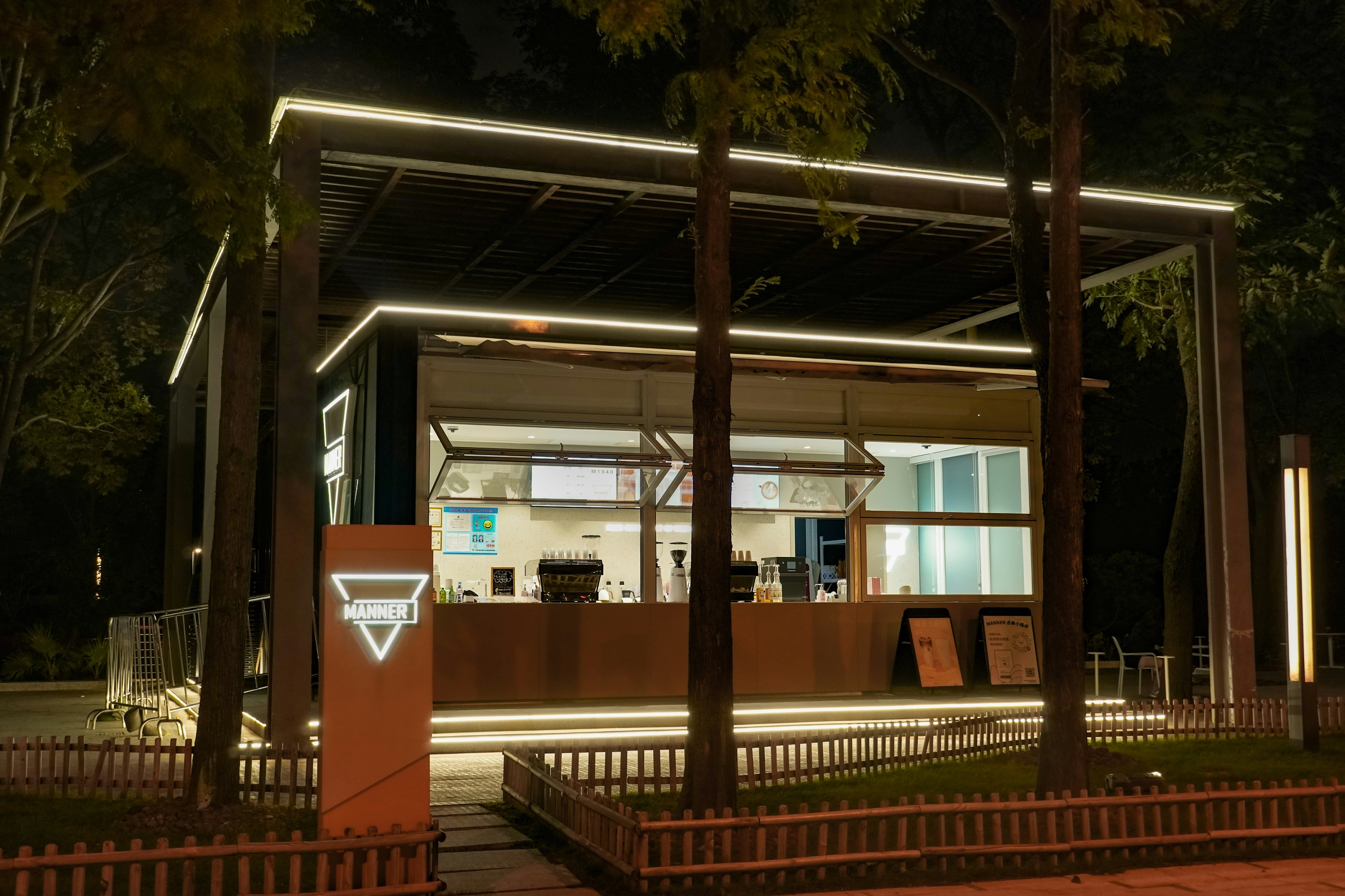 Small coffee shop building with illuminated sign