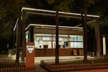 a small building with a lit up sign in front of it
