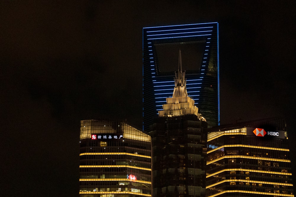 a very tall building in the middle of a city at night