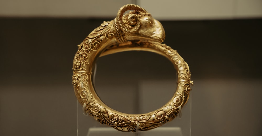 a gold ring with an animal head on it