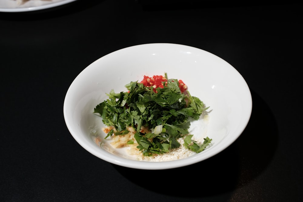 a white bowl filled with food on top of a table