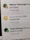 A digital notification on a screen announces the achievement of reaching 500,000 downloads. The message is accompanied by a gold trophy icon symbolizing success. The background shows other notifications with interactions from a social media platform.
