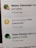 A digital notification on a screen announces the achievement of reaching 500,000 downloads. The message is accompanied by a gold trophy icon symbolizing success. The background shows other notifications with interactions from a social media platform.