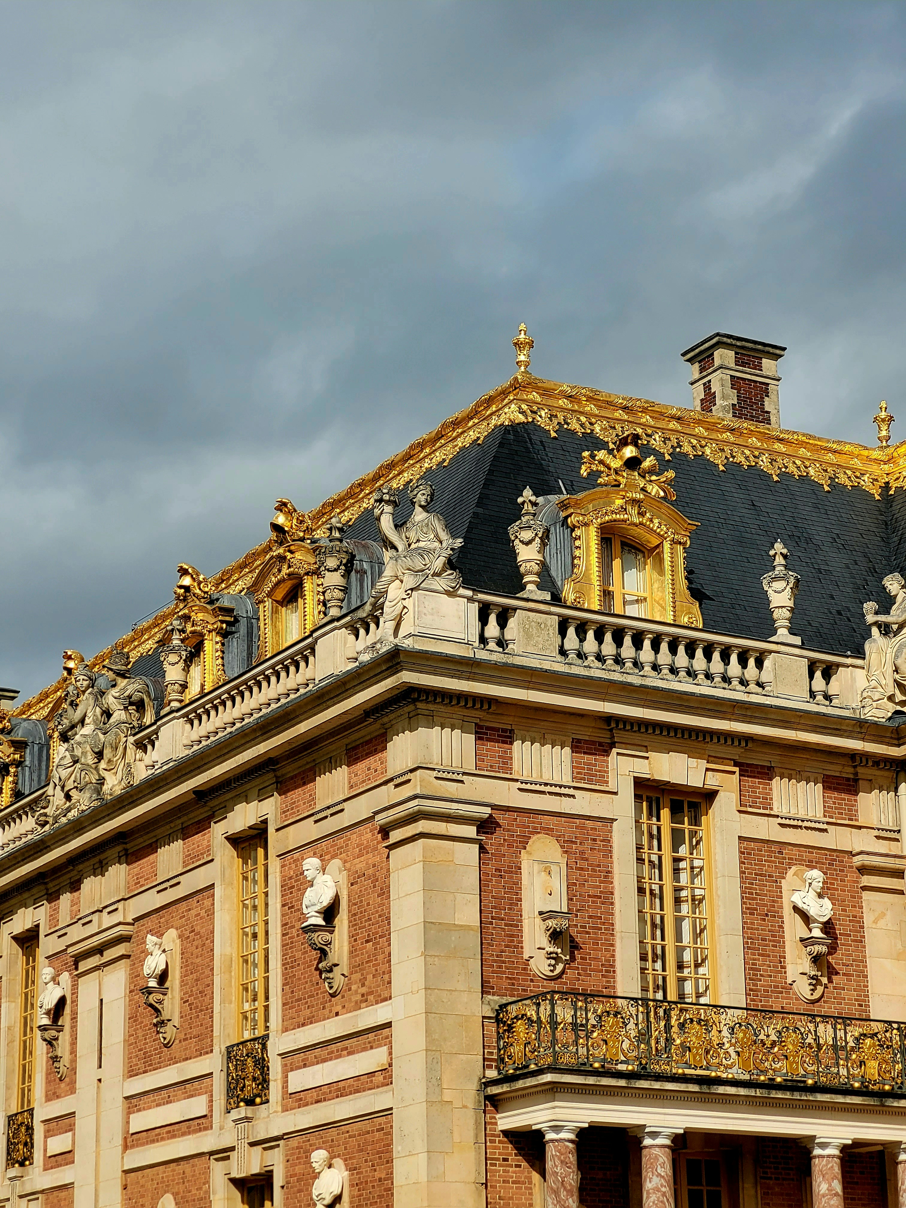 a large building with statues on the top of it