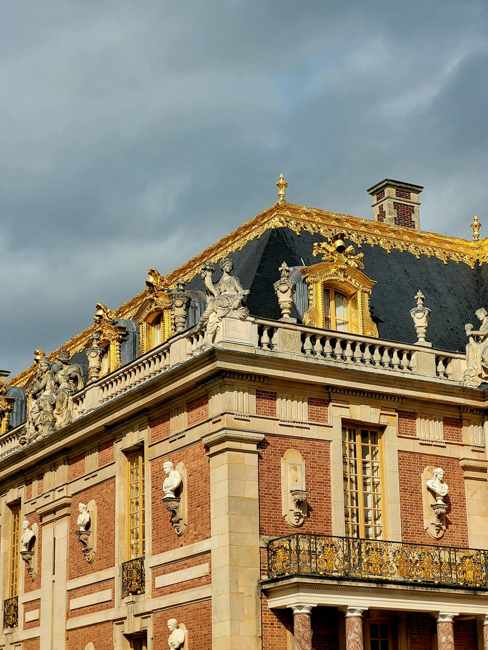 a large building with statues on the top of it