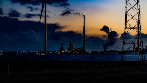 A dynamic visualization of air dispersion patterns over an industrial site at sunset.