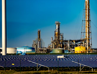 A modern energy facility with solar panels and wind turbines working together.