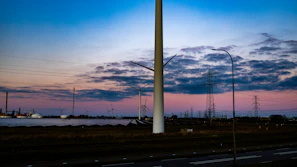 Aerial view of a wind farm connected to energianova's energy management platform at sunset