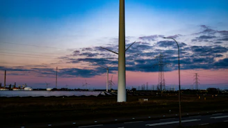 Aerial view of a wind farm connected to energianova's energy management platform at sunset