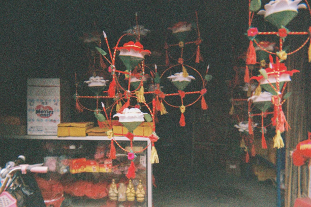 A warm, inviting storefront of Patel Grocers decorated with colorful Indian festival decorations.