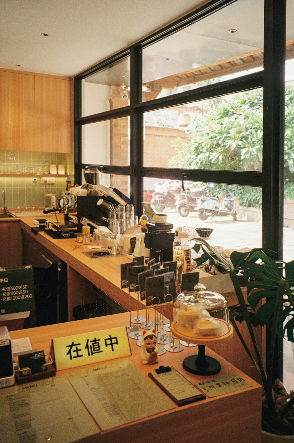 a restaurant counter with a menu and wine glasses on it