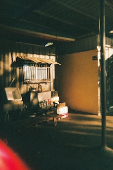 A dimly lit vintage room with textured film grain and soft shadows.