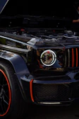 Close-up of a sleek black air suspension system with gold accents on a luxury SUV.