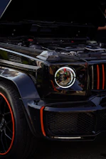 Close-up of a professional mechanic using advanced diagnostic equipment on a luxury SUV.