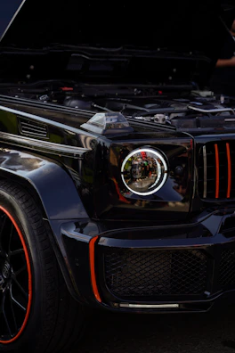 Close-up of a sleek black air suspension system with gold accents on a luxury SUV.