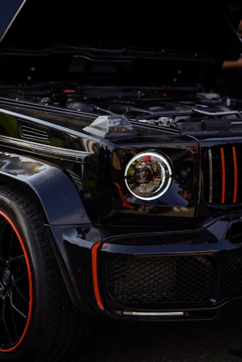 Close-up of a professional mechanic using advanced diagnostic equipment on a luxury SUV.