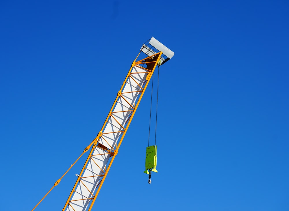 a crane is lifting a piece of material into the air