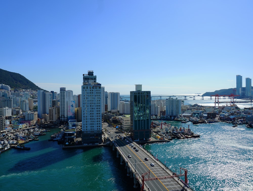 a bridge over a body of water with a city in the background