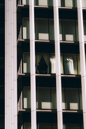 Close-up of a curtain wall featuring transparent photovoltaic glass capturing sunlight.