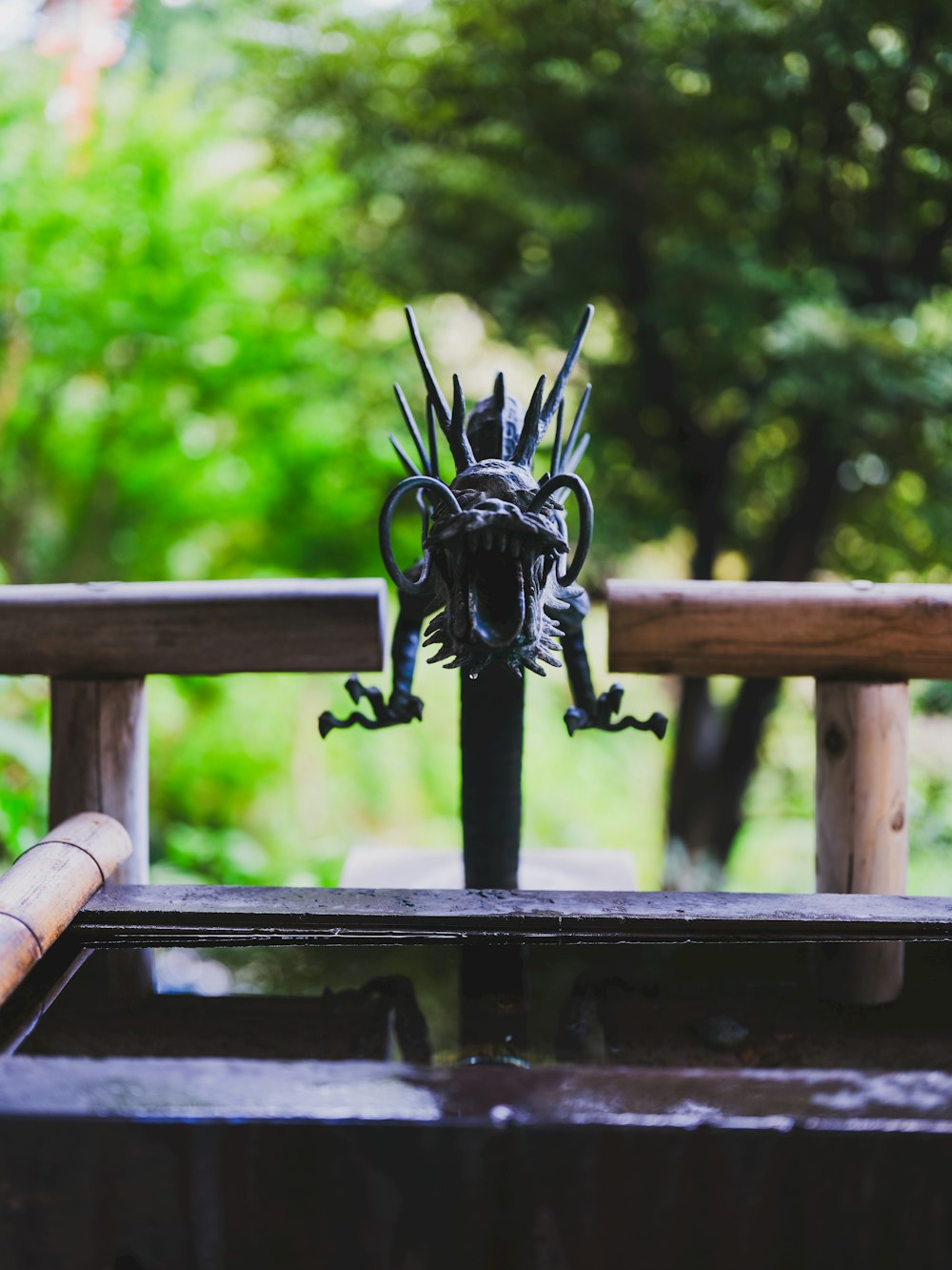 a statue of a dragon on top of a wooden bench