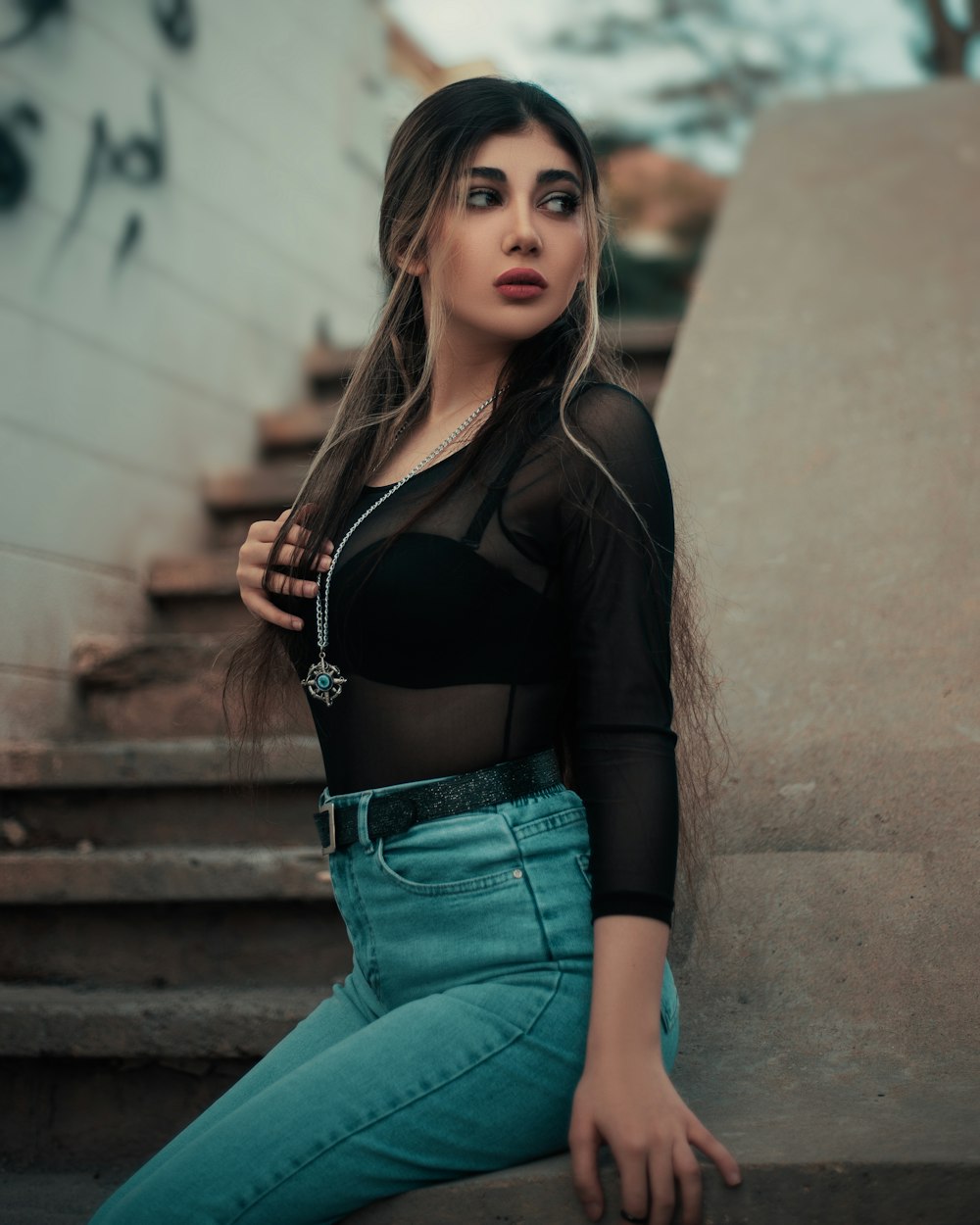 a woman sitting on the steps of a building