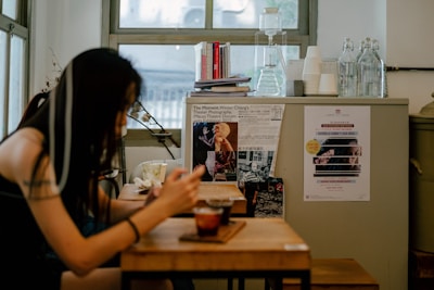 A person using a mobile app in a cozy kitchen setting.