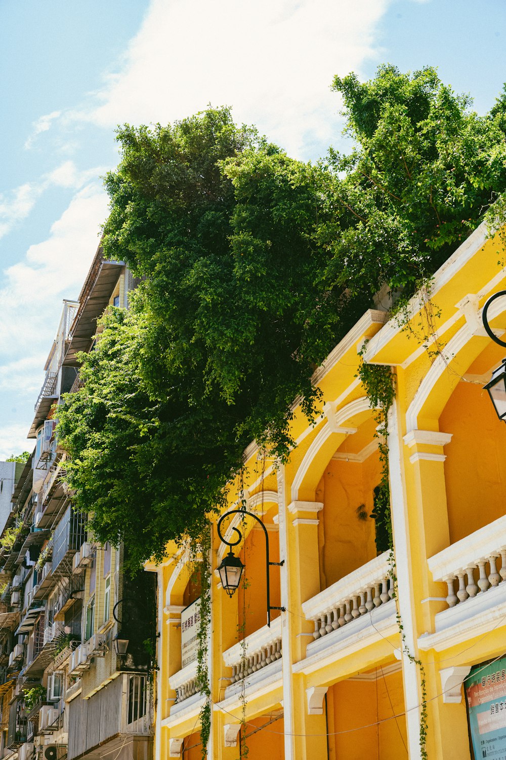 a yellow building with a clock on the front of it