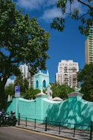 a blue building with a clock tower in the background