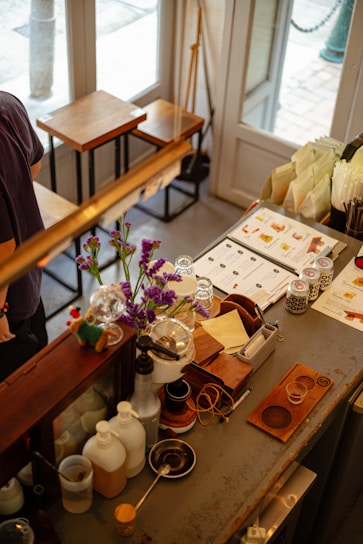 A cozy café counter with neatly packed surplus food bundles ready for pickup, bathed in warm natural light.
