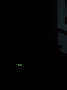 A digital alarm keypad glowing softly in a dimly lit room