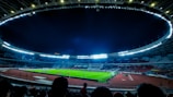 A vibrant photo of a soccer match under bright stadium lights at Galaxy Sports Club