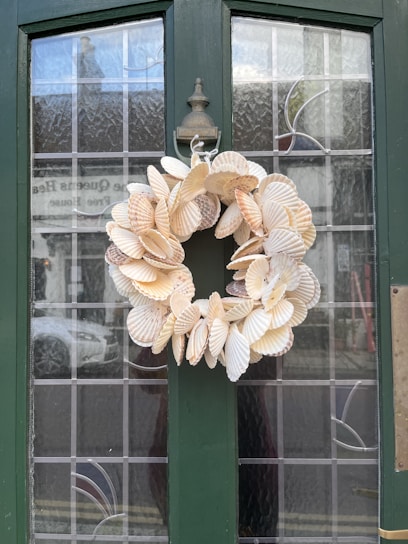 A collection of elegant wreath decorations and coastal runner rugs.