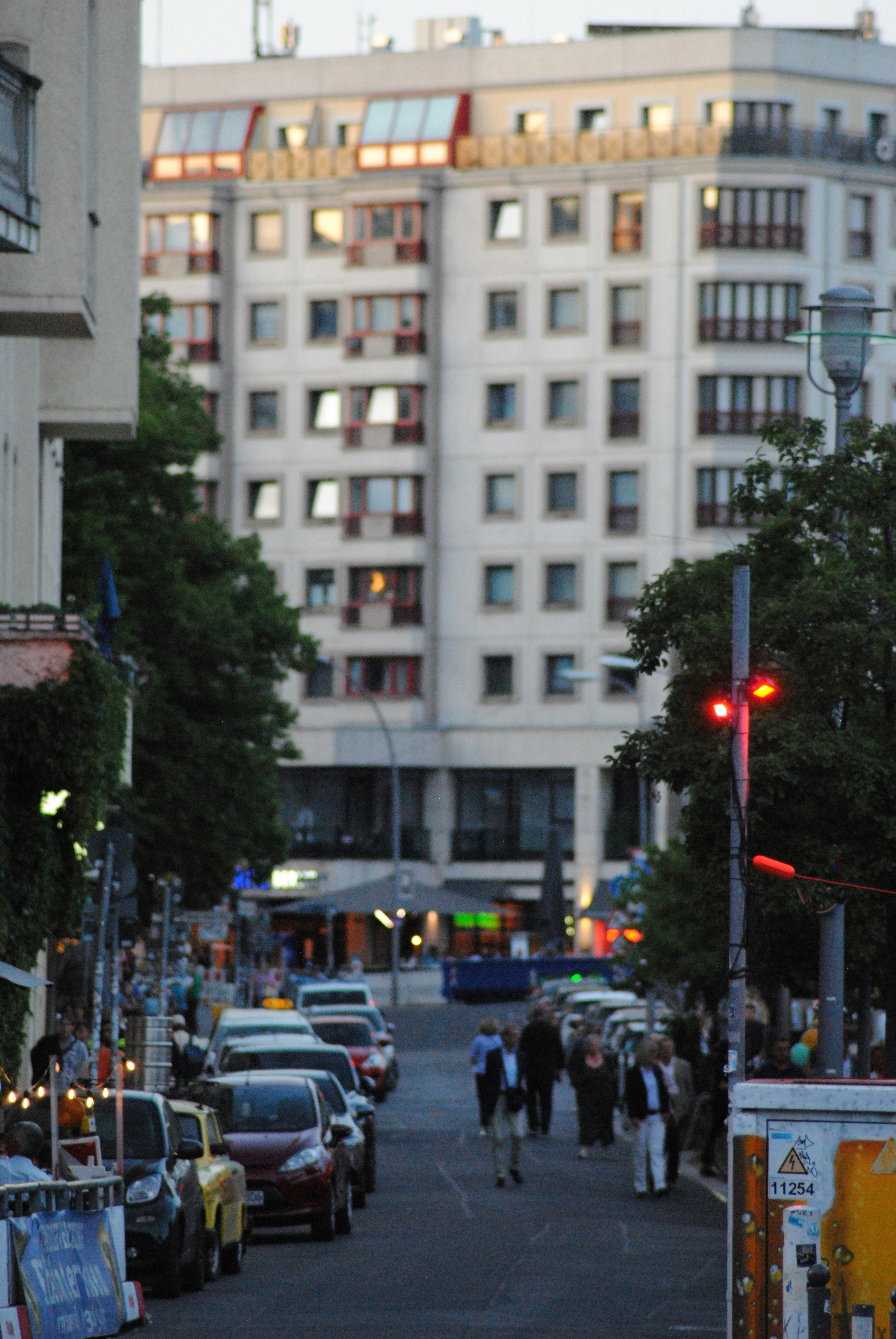 a city street filled with lots of traffic next to tall buildings