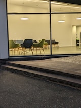 Team meeting in a clean, minimalist office with green highlights.