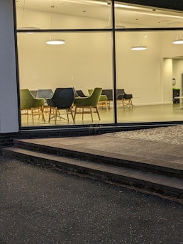 Team meeting in a clean, minimalist office with green highlights.