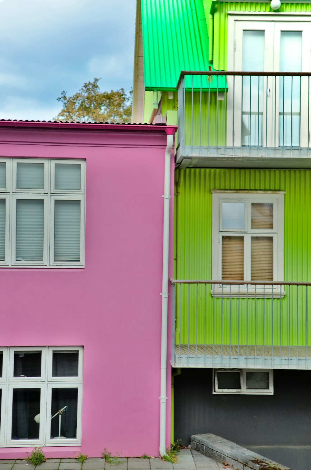 a couple of buildings that are painted pink and green