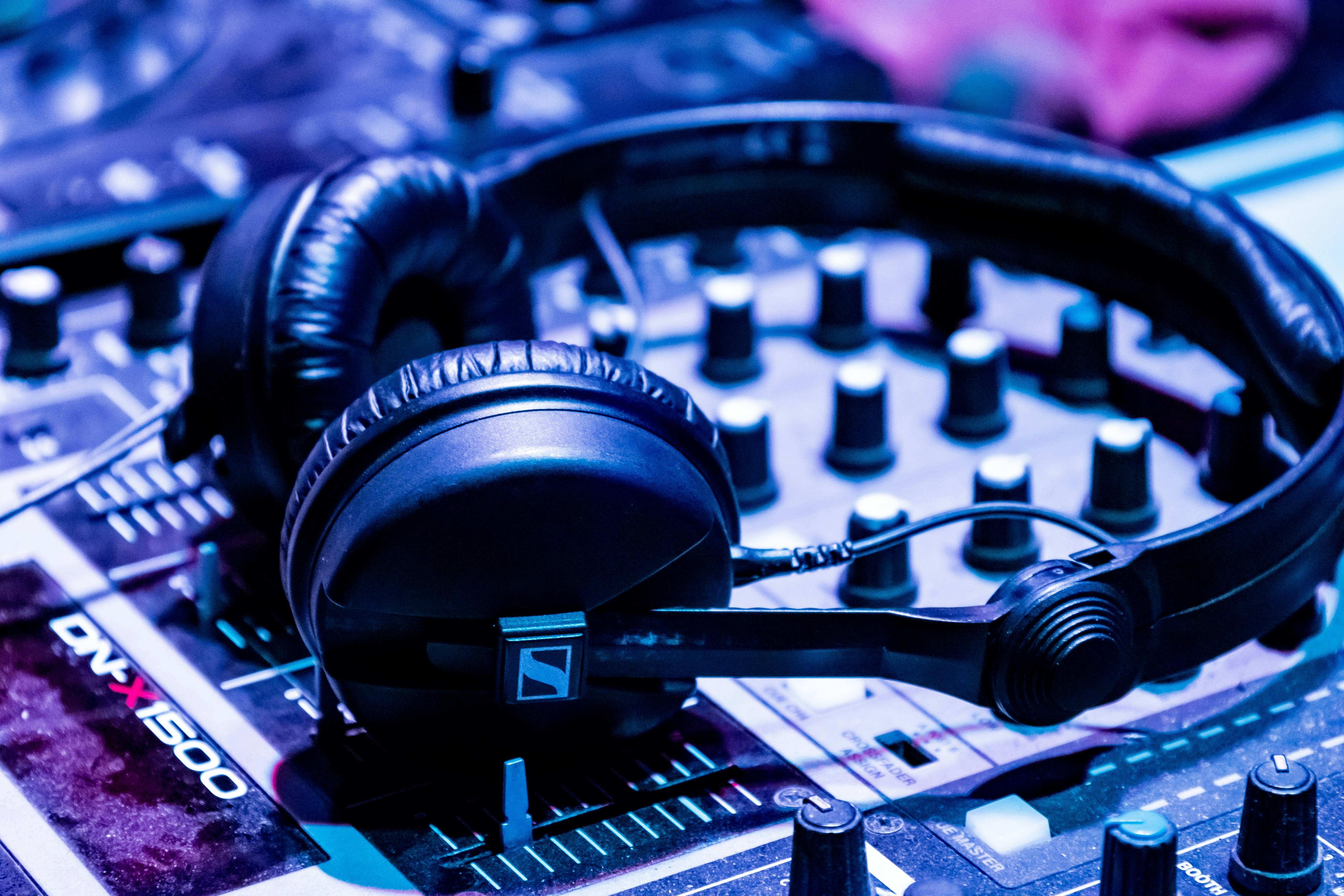 a pair of headphones sitting on top of a mixing board