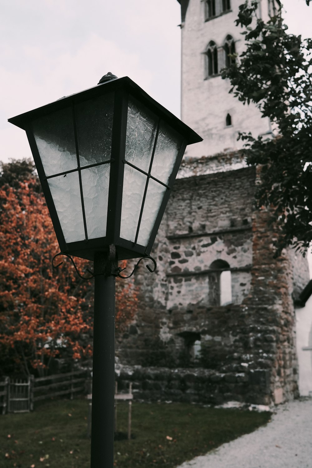 a street light in front of a stone building