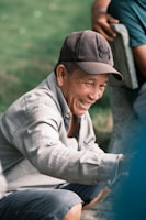 Friendly staff member sharing a smile with an elderly resident outdoors
