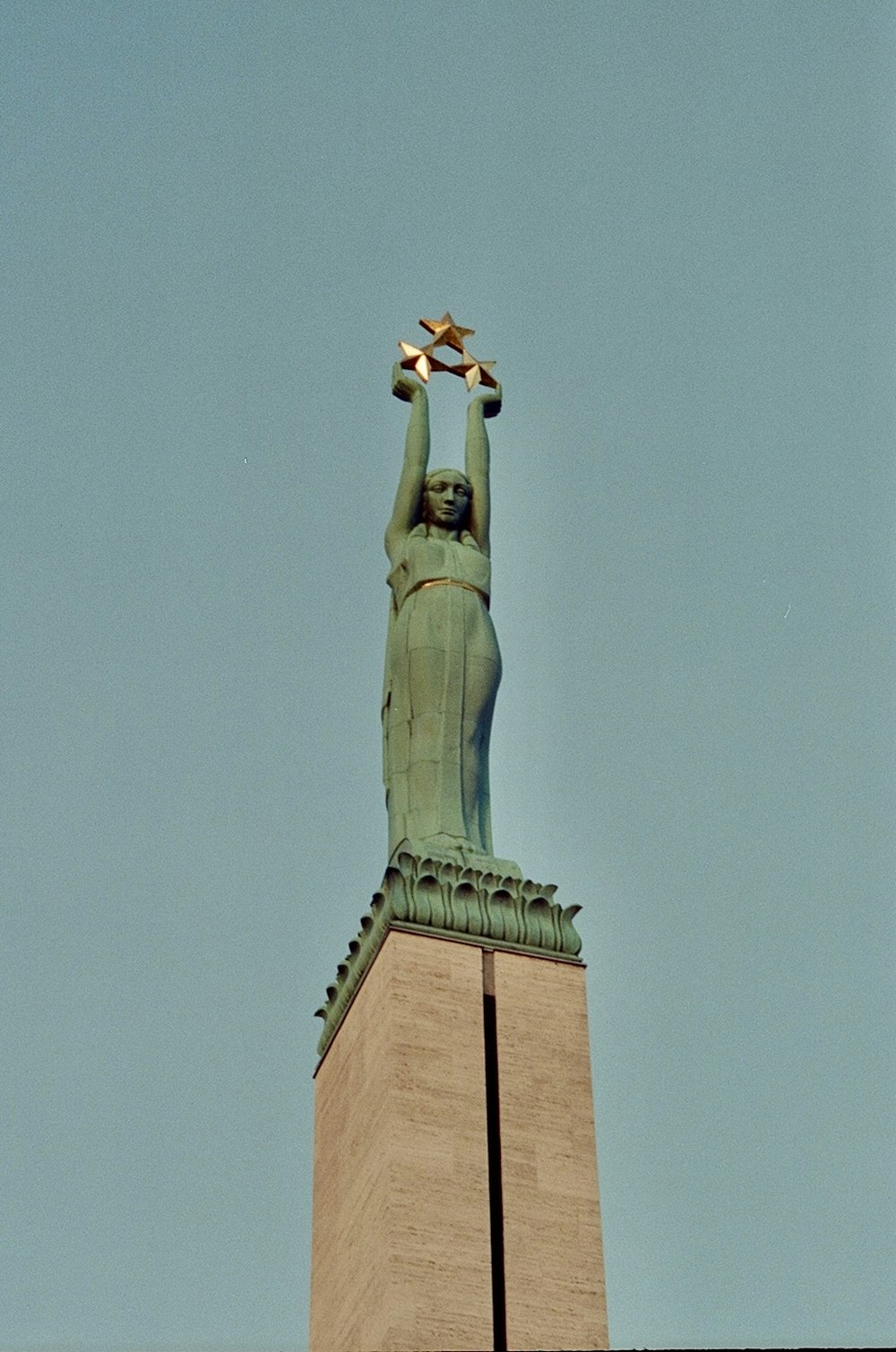 a statue of a woman holding a star above her head