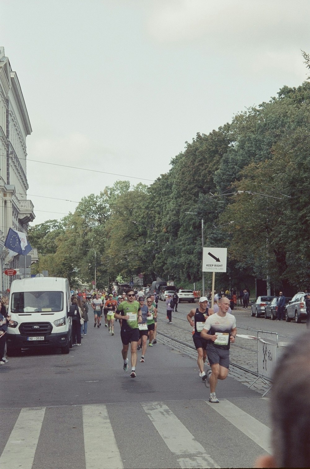 a group of people running down a street
