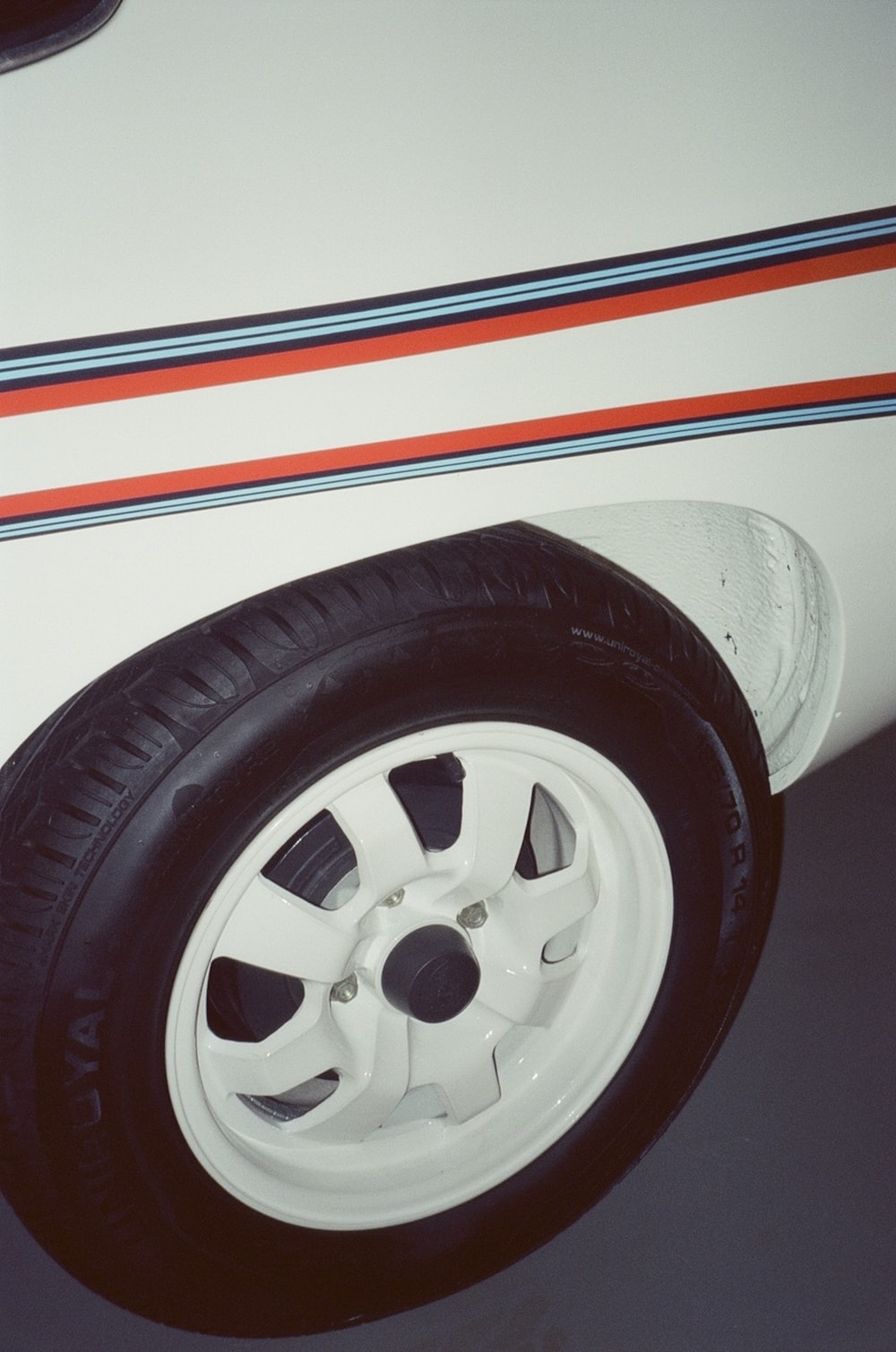 a close up of a tire on a white car