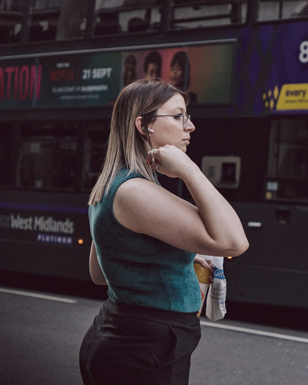 a woman standing on the side of the road