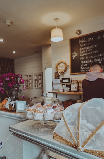A cozy café setting with a variety of pastries on display.