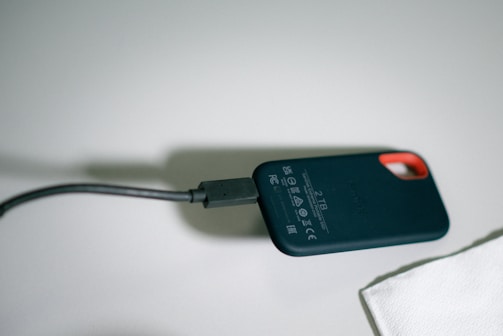 External solid-state drive with a compact design placed next to a laptop.