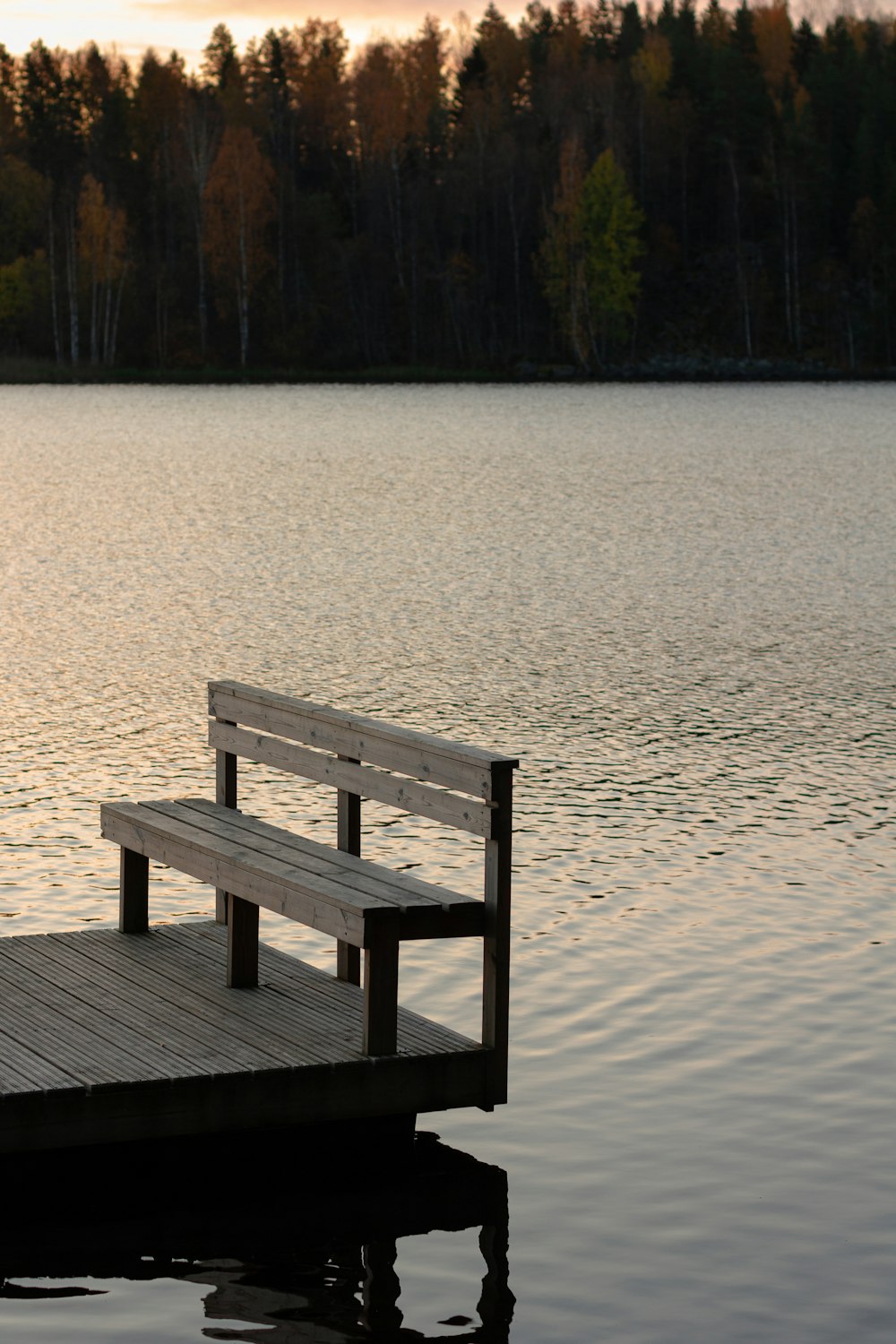 a bench sitting on top of a wooden dock
